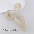 Close-up of a jelly cream bow-shaped hair claw clip with smooth resin texture and gold spring - Jelly Off-white