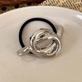 Detail of minimalist black hair tie with polished silver twisted metal knot accessory - Silver Knot