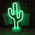 Green cactus neon sign lamp with white base on wood surface against a grid wall - Green Cactus