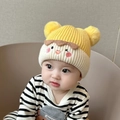Cute yellow and cream knit baby hat with dual pom-poms and cartoon embroidery - Kids Blush Face - Yellow