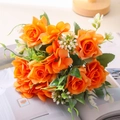 Ramo de rosas naranjas artificiales con flores blancas sobre una revista decorativa - Naranja