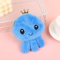 Detail of blue octopus plush coin purse with gold crown and embroidery on pink background - Blue