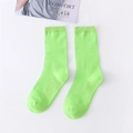 Neon green ribbed cotton crew socks for women displayed on white background with magazine - Fruit Green