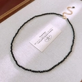 Detailed shot of a black faceted bead necklace with gold clasp on textured fabric - Fine Beaded With Small Pendant Style (12#)