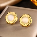 Close-up of vintage gold titanium earrings with white opal stone and pavé accents - Gold White Cat Eye