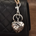 Heart-shaped leopard print keychain accessory hanging on a black quilted leather handbag - Leopard Large Heart
