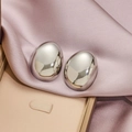 Minimalist silver geometric bean stud earrings in a polished oval pebble shape design - Steel