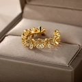Detailed view of gold flower rings with pavé cubic zirconia in a jewelry gift box - Gold Flower Row (G6071553)