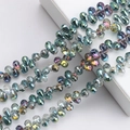 Macro shot of colorful iridescent 6x9mm teardrop glass beads for DIY jewelry making - 100 Pcs/Pack / Rose Red Green