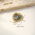 Gold plated heart pendant necklace featuring a dark carved shell and angel motif - Lace Heart Sun God (Black Shell)