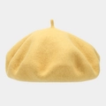 Detail of a vintage ginger yellow wool beret with soft felt texture and classic top stem - One Size / Chick Yellow