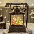 Vintage bronze telephone Christmas snow globe with Santa Claus and festive LED light - Retro Telephone Santa and Child