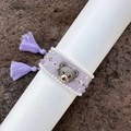 Handmade purple woven bracelet featuring a sparkling bear charm and stylish tassels. - Lavender
