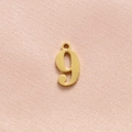 Close-up of polished gold stainless steel number 9 charm for necklaces and bracelets - Gold Number 9