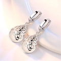Gros plan de boucles d'oreilles gouttes avec motifs évidés en argent et incrustations d'opale - Boucles d'Oreilles Oeil de Chat Wishing Well - Blanc