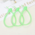 Three neon green silicone cable ties with adjustable loop design on a neutral background - Luminous Green