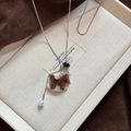 Macro view of brown flocked rocking horse pendant with rhinestones and pearl detail - Silver Chain-Brown Rocking Horse Style