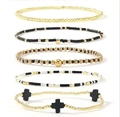 Five-piece beaded bracelet set featuring golden beads and black cross charms - Black Gold 5-Piece Set