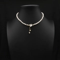 Elegant gold necklace with white natural pearls and shell flower pendant on black bust - Flower Tassel Pendant Artificial Pearl Necklace