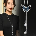 Detailed close-up and model view of a silver necklace with blue butterfly pendant - Little Blue Butterfly Necklace (129)