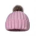 Detail of pink knit beanie showing ribbed texture and fluffy brown faux fur pompom - One Size / Pink