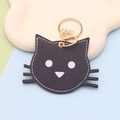 Portachiavi gatto nero in ecopelle con anello dorato e cuciture bianche a contrasto - Stile portachiavi / Gatto nero