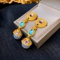 Detailed close-up of vintage gold earrings with colorful gemstones and pearls on a jewelry box - Silver Earring Post - Colorful