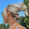 Light blue flower-shaped hair claw clip for women styled in a natural outdoor setting - Light Blue
