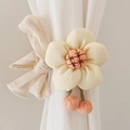 Close-up of beige fabric flower curtain tieback with embroidery and pink pom-poms - Beige (Cotton Five-Petal Flower)