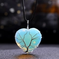 Macro shot of silver wire tree of life wrapped on a blue heart opal stone pendant - Opal