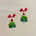 Detail showing crystal beaded Christmas tree earrings with red bows and white pearls - Bow Pearl Christmas Tree-Silver Pin / Stud Earrings
