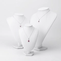 Silver necklace with red gemstone pendant on white mannequin stand for jewelry display - Large / White Leather