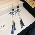 Close-up of fan-shaped earring with blue bamboo pattern and marble resin pendant - Fan Tassel Ear Hook