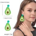 Detail view of avocado acrylic earrings showing dimensions 6.8cm length and model fit - Avocado