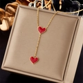 Golden necklace with red enamel heart pendants displayed on a beige jewelry box - Red Enamel Double Heart Style (N1910)