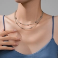 Double-layered silver PVD titanium steel necklace with oval beads on a female model - Steel Color Layered Rice Bead Chain