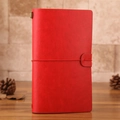 Red leather vintage travel journal with elastic strap and antique metal bead detail - Red Traveler's Notebook