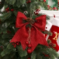 Detail of red glitter Christmas bow with pine cones and berries hanging on a green tree - 25cmx30cm / Red