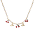 Close-up of pearl bead necklace with red cherry pendants and gold metallic accents - Gold Smooth Cherry & Red Cherry Necklace