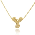 Macro shot of gold-plated letter Y pendant with crystal pavé and box chain detail - Letter Y