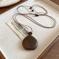 Close-up of a vintage wood pendant necklace in a wooden box with linen padding - 53# Necklace-Coffee-Wine Bag