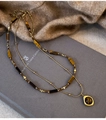 Detail of layered gold necklace with tiger eye stones on blue book and camel knitwear - Gold Double Layer Tiger Eye Style (3#)