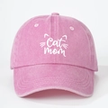 Close-up of pink washed cotton cap featuring white Cat Mom embroidery and cat whiskers - Pink
