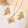 Macro detail of gold irregular leaf textured pendant and earrings on a white stand - Irregular Folded Leaf Style (E3613-1)