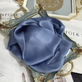 Detail of elegant dark blue pure silk scarf folded on a vintage tray with soft luster - 15x150cm / Haze Blue