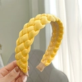 Detail of yellow braided satin headband with glossy silk texture and wide weave design - Yellow