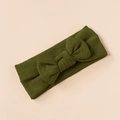 Olive green waffle knit baby headband featuring a large textured bow detail on beige background - Dark Green