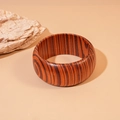 Close-up of wide wooden bangle with natural dark grain textures against stone decor - Dark Coffee Wide Stripe (2#)