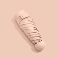 Pink mini capsule umbrella in a compact folded design for sun and rain protection - 6-Rib Mini Vinyl Thickened / Grapefruit Pink