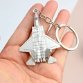 Silver metal airplane keychain held in hand to demonstrate size and fighter jet details - Silver J-35 Fighter Jet
